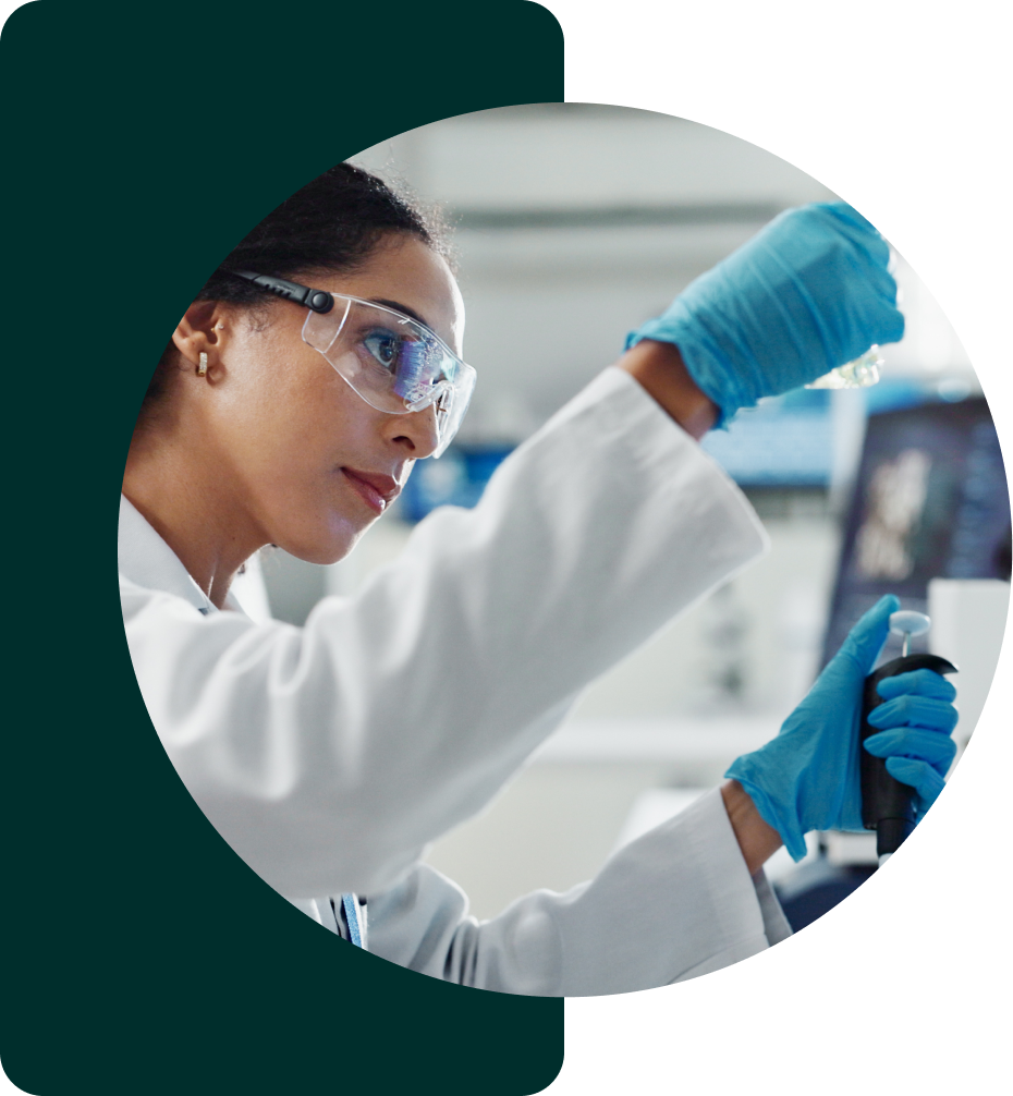 Female scientist with pipet looking at sample tube.