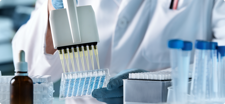 A lab technician handling a multichannel pipette.