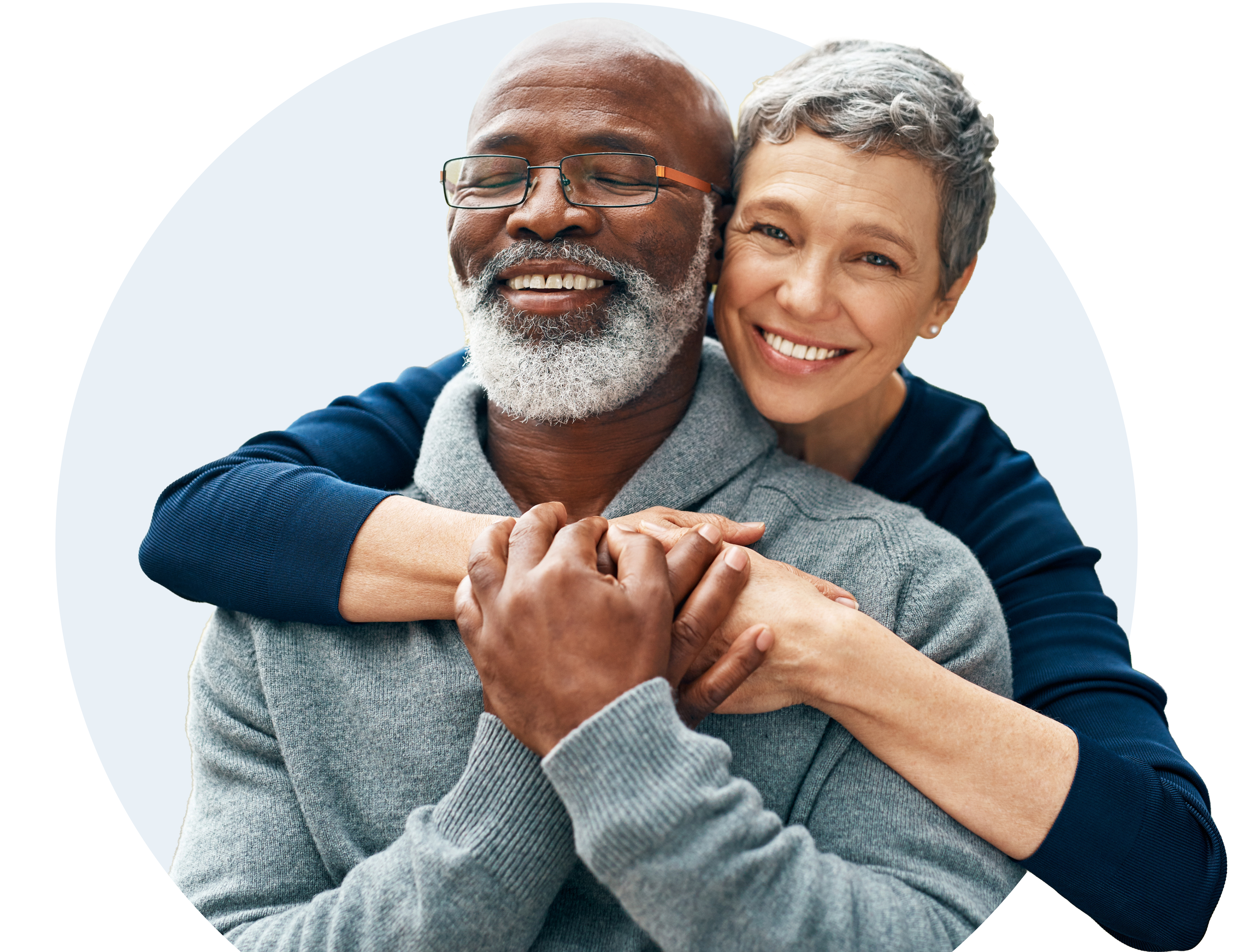 A smiling couple embraces each other.