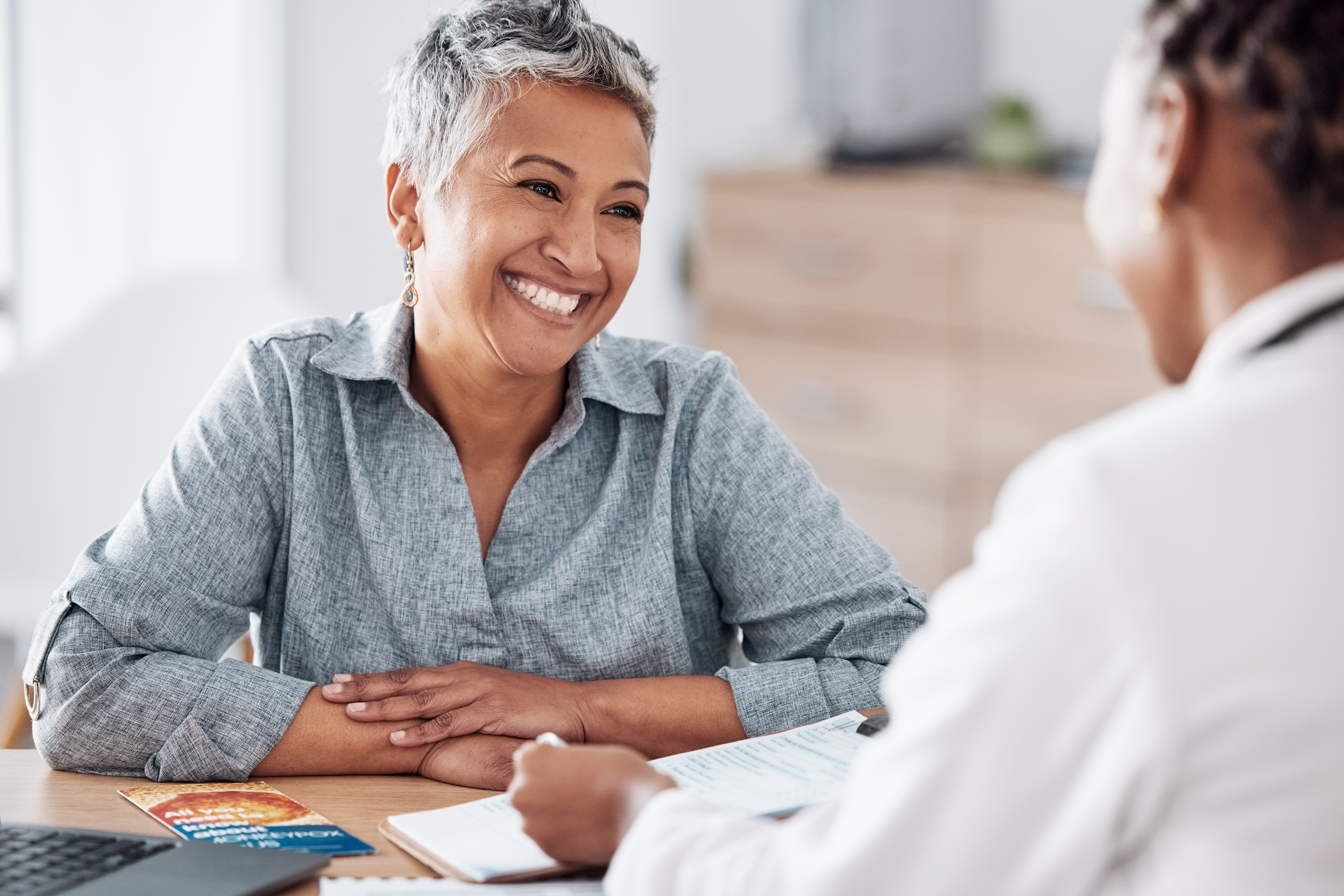 A person smiling at a physician.