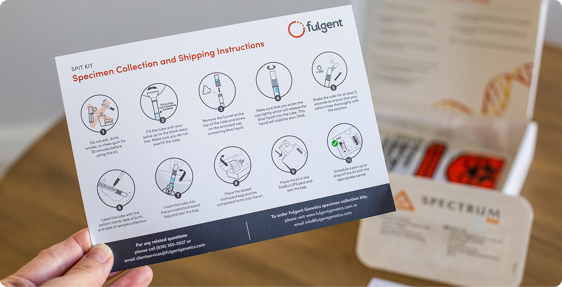 A hand holding out an instruction card for sample collection